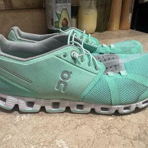 On Running Green and Gray Sneakers with CloudTec Cushioning